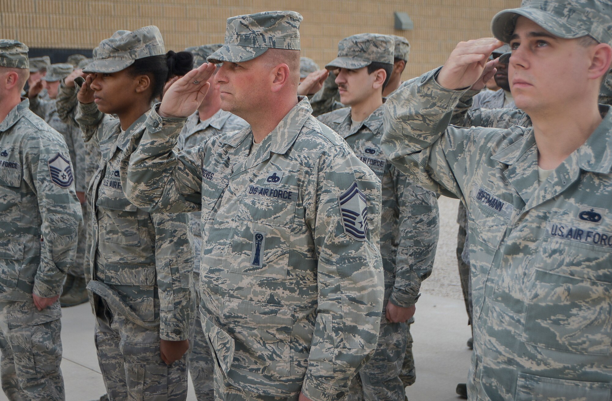 Airmen from the 379th Expeditionary Maintenance Group salute the U.S. Flag during a Presidents Day retreat ceremony at Al Udeid Air Base, Qatar, Feb. 17, 2014. In 1951, the desire for a more generalized recognition of Presidential achievements surfaced and collided with a movement to standardize the observance of certain holidays on Mondays, which would later come to be known as the “Uniform Monday Holiday Act”. Contrary to popular belief, the act neither combined the birthday celebrations for Presidents George Washington and Abraham Lincoln nor actually changed the holiday’s official name to Presidents Day.  (U.S. Air Force photo/Senior Airman Jared Trimarchi) 