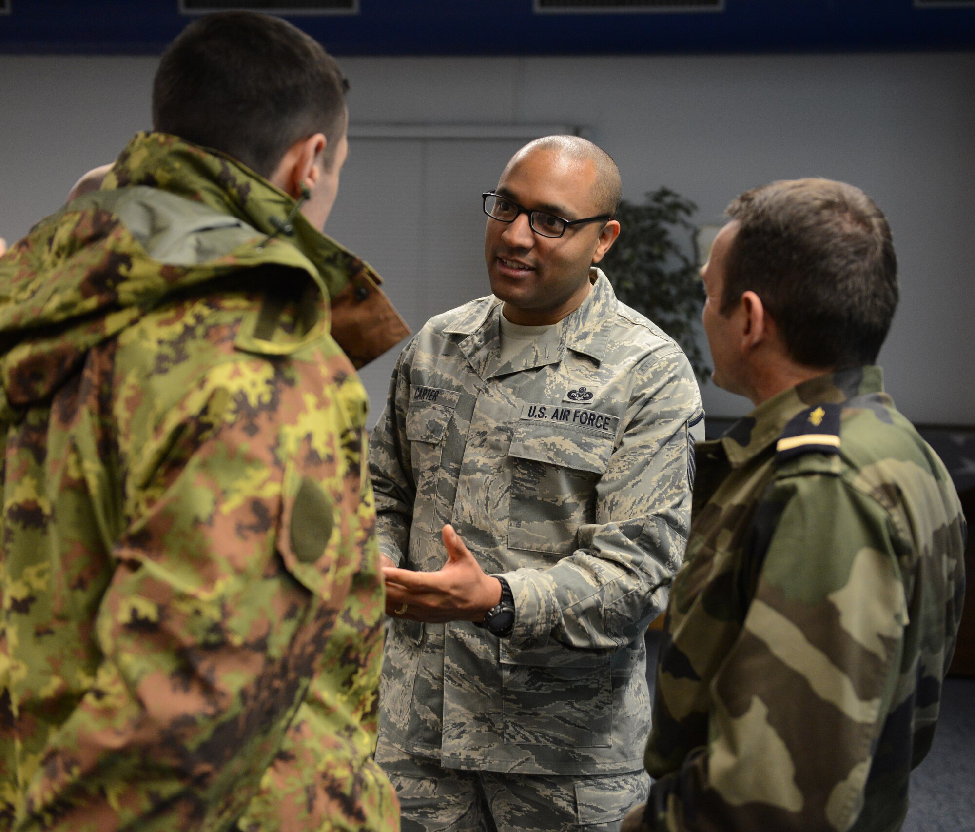 KAPAUN AIR STATION, Germany --  Master Sgt. Waverly Carter, 86th Airlift Wing Staff Judge Advocate Office, chats with two international attendees of the Kaiserslautern Military Community First Sergeant Council's Additional Duty First Sergeant Symposium here Feb. 18. Carter said he attended the symposium to learn more about the first sergeant position. More than 120 non-commissioned officers from nine nations took part in the event.  (U.S. Air Force Photo by Tech. Sgt. James M. Hodgman) 