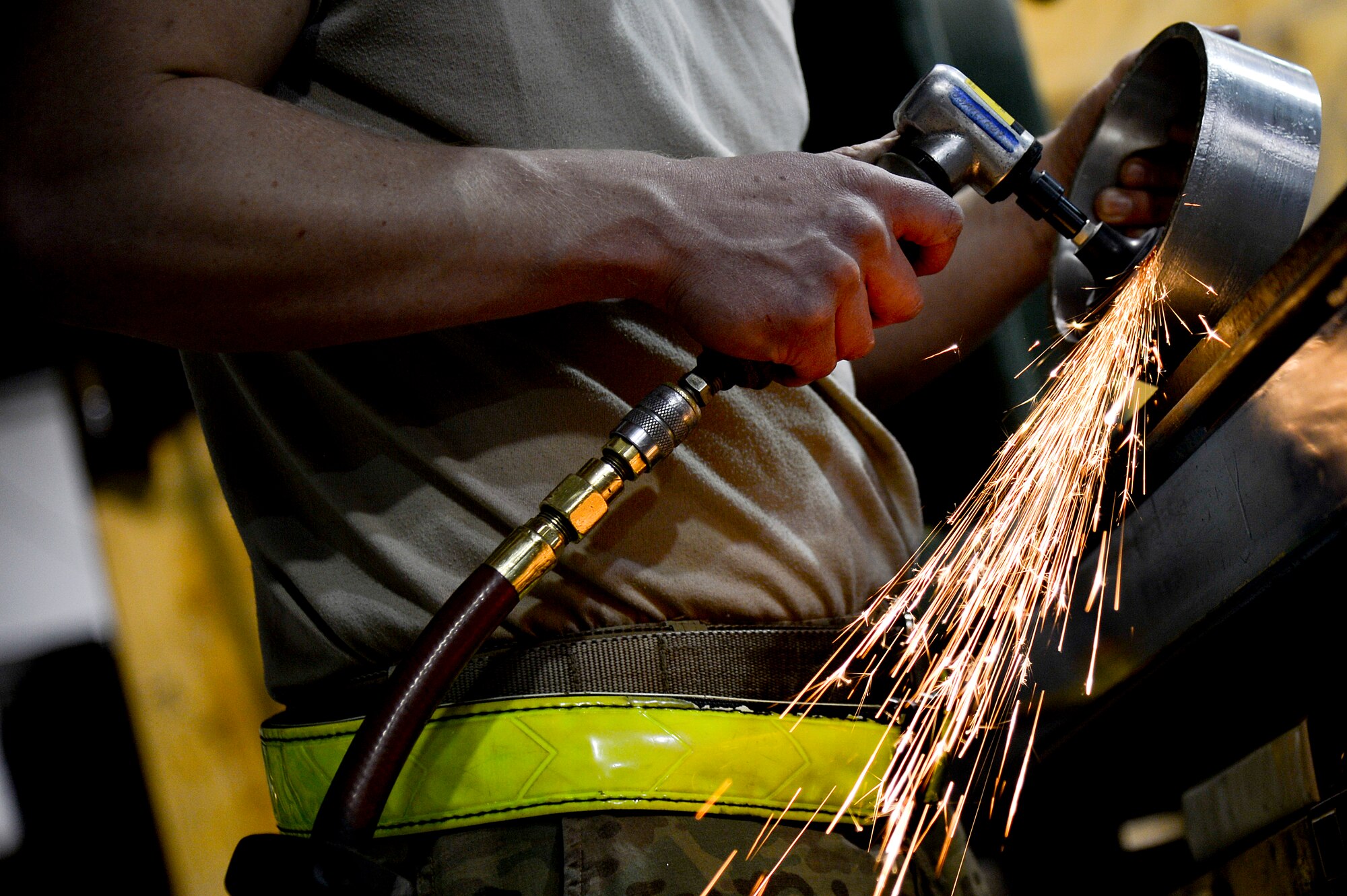 U.S. Air Force Senior Airman Allan Rosso, 455th Expeditionary Maintenance Squadron aircraft metals technologist, grinds the edges of a forward fuel pylon attach fitting wrench kits at Bagram Airfield, Afghanistan, Feb. 20, 2014. The part is used for the external fuel tank pylons on the F-16 Fighting Falcons. Rosso is deployed from Moody Air Force Base, Ga., and a native of Porterville, Calif. (U.S. Air Force photo by Senior Airman Kayla Newman/Released)