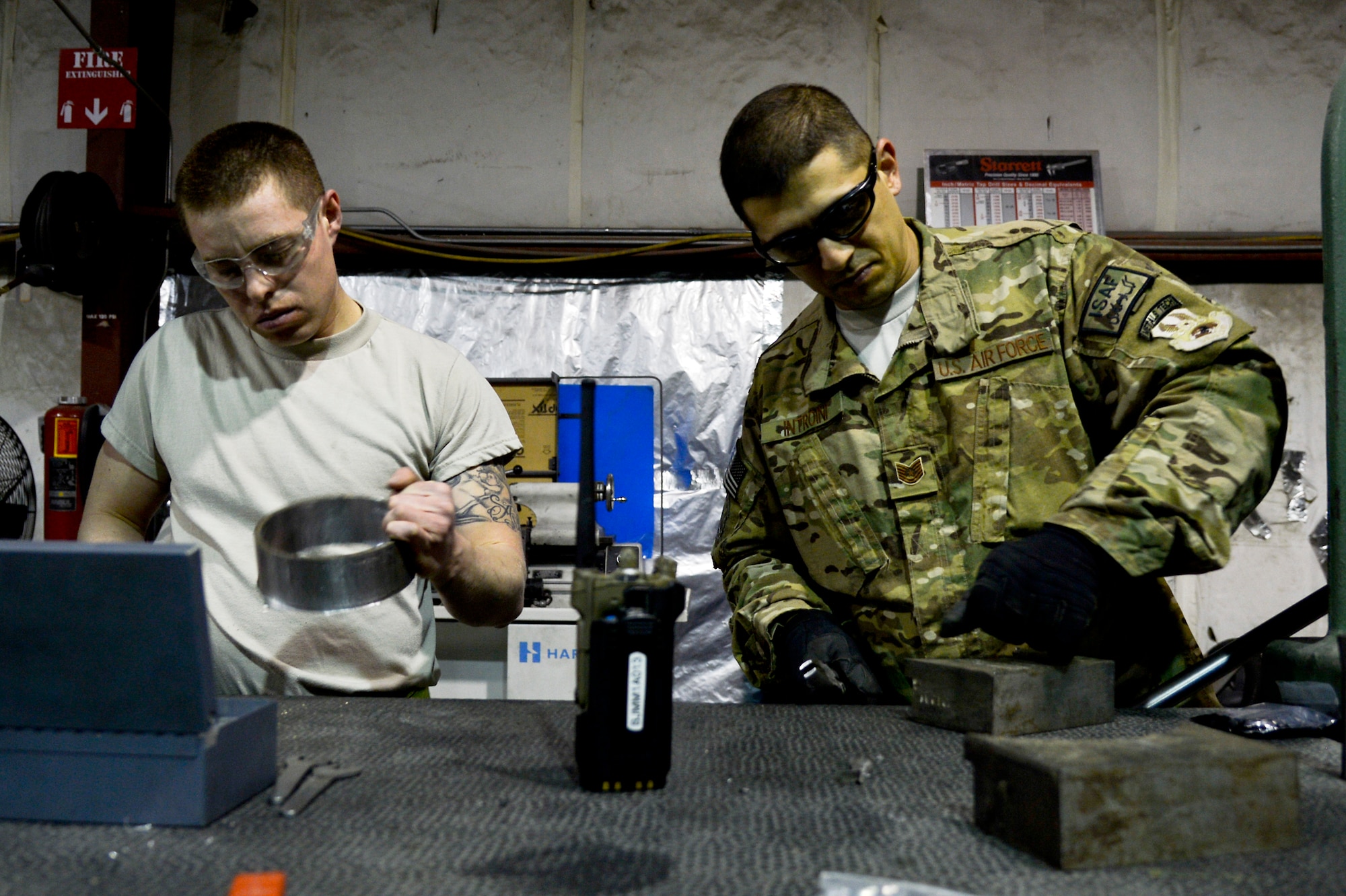 U.S. Air Force Tech. Sgt. Alex Introini, 455th Expeditionary Maintenance Squadron aircraft machinist and welder, and Senior Airman Allan Rosso, 455 EMXS aircraft metals technologist, manufacture a forward fuel pylon attach fitting wrench kit at Bagram Airfield, Afghanistan, Feb. 20, 2014. The part is used for the external fuel tank pylons on the F-16 Fighting Falcons. Introini is deployed from Homestead Air Reserve Base, Fla., and Rosso is deployed from Moody Air Force Base, Ga. (U.S. Air Force photo by Senior Airman Kayla Newman/Released)

