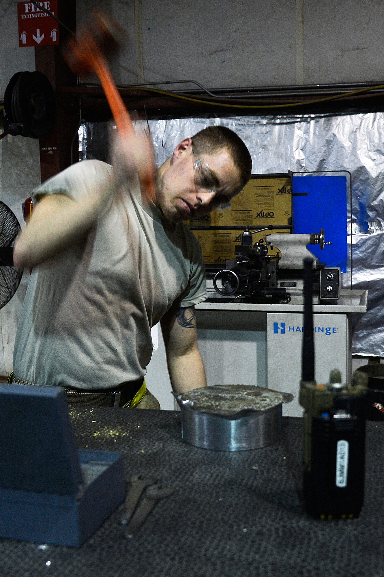 U.S. Air Force Senior Airman Allan Rosso, 455th Expeditionary Maintenance Squadron aircraft metals technologist, uses a hammer to smooth the edges of a forward fuel pylon attach fitting wrench kit at Bagram Airfield, Afghanistan, Feb. 20, 2014. Rosso manufactured the part to be used for the external fuel tank pylons on the F-16 Fighting Falcons. Rosso is deployed from Moody Air Force Base, Ga., and a native of Porterville, Calif. (U.S. Air Force photo by Senior Airman Kayla Newman/Released)

