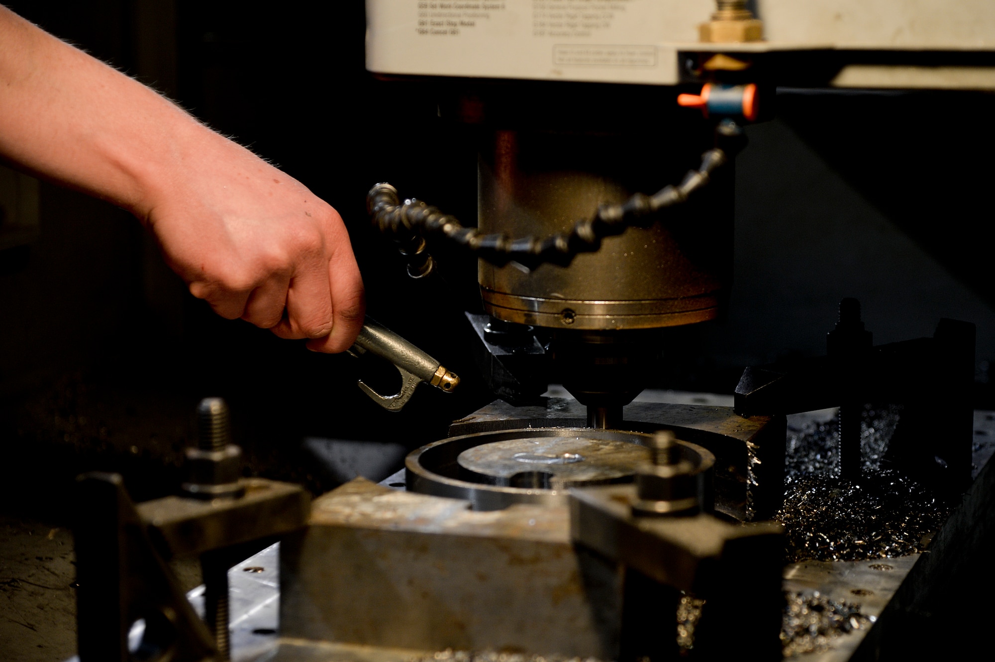 U.S. Air Force Senior Airman Allan Rosso, 455th Expeditionary Maintenance Squadron aircraft metals technologist, operates a machine used for making forward fuel pylon attach fitting wrench kits at Bagram Airfield, Afghanistan, Feb. 20, 2014. The part is used for the external fuel tank pylons on the F-16 Fighting Falcons. Rosso is deployed from Moody Air Force Base, Ga., and a native of Porterville, Calif. (U.S. Air Force photo by Senior Airman Kayla Newman/Released)