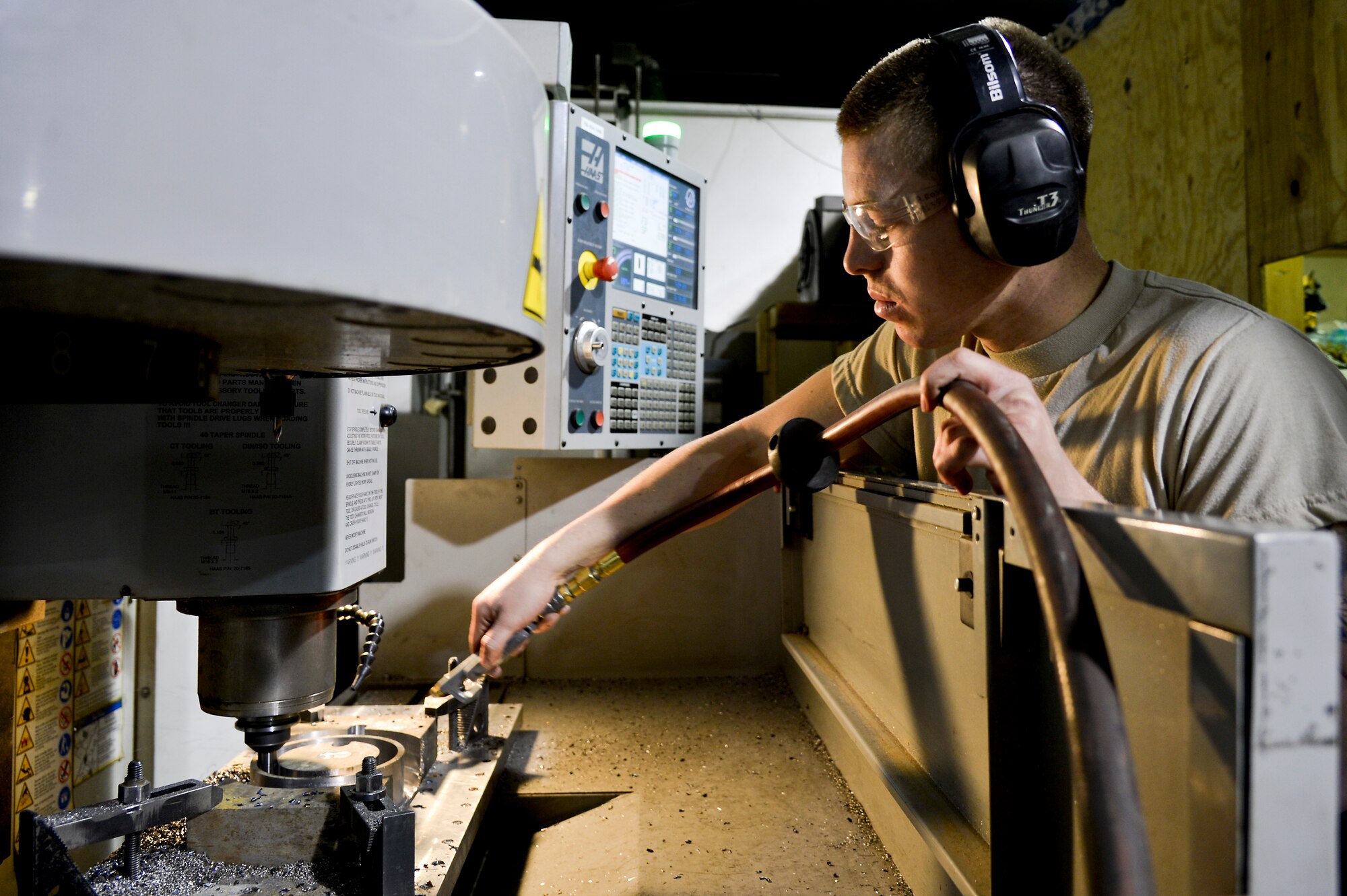 U.S. Air Force Senior Airman Allan Rosso, 455th Expeditionary Maintenance Squadron aircraft metals technologist, operates a machine used for making forward fuel pylon attach fitting wrench kits at Bagram Airfield, Afghanistan, Feb. 20, 2014. The part is used for the external fuel tank pylons on the F-16 Fighting Falcons. Rosso is deployed from Moody Air Force Base, Ga., and a native of Porterville, Calif. (U.S. Air Force photo by Senior Airman Kayla Newman/Released)
