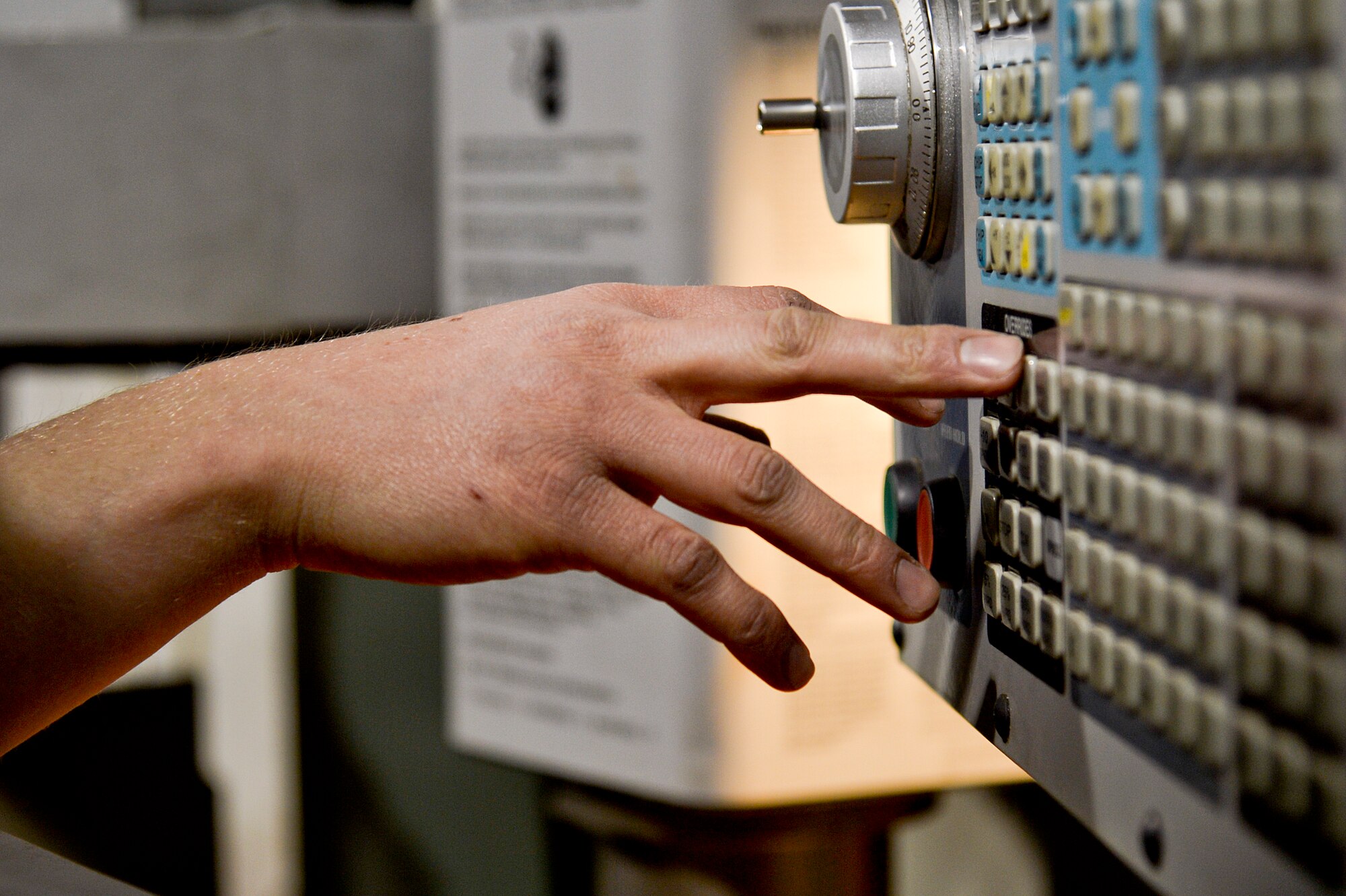 U.S. Air Force Senior Airman Allan Rosso, 455th Expeditionary Maintenance Squadron aircraft metals technologist, operates a machine used for making forward fuel pylon attach fitting wrench kits at Bagram Airfield, Afghanistan, Feb. 20, 2014. The part is used for the external fuel tank pylons on the F-16 Fighting Falcons. Rosso is deployed from Moody Air Force Base, Ga., and a native of Porterville, Calif. (U.S. Air Force photo by Senior Airman Kayla Newman/Released)