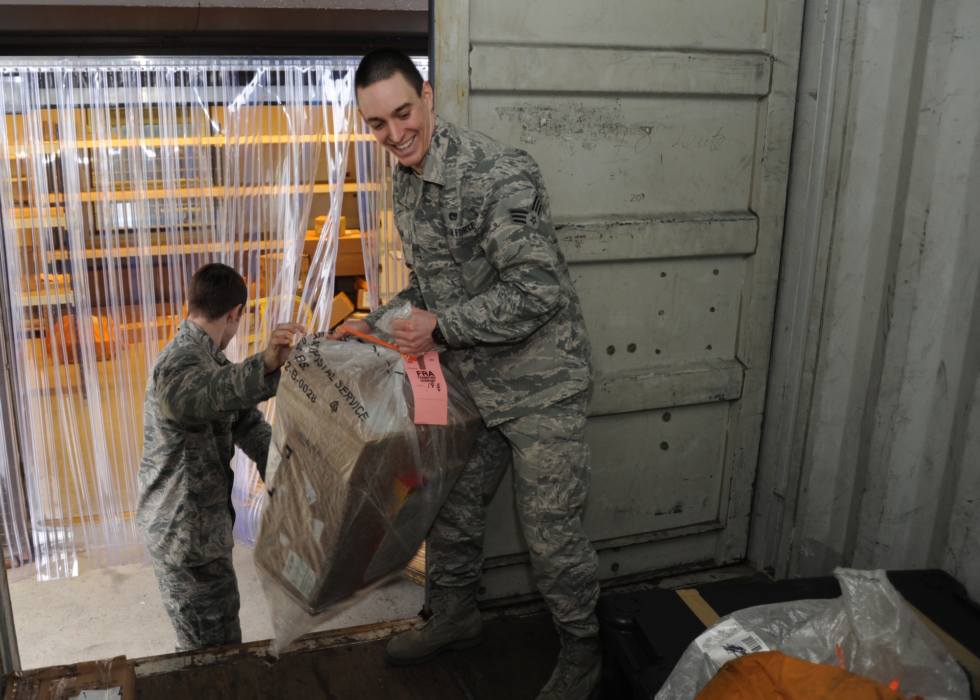 U.S. Air Force Senior Airmen Matthew Baker, left, and John Thurman, right, 52nd Communications Squadron military postal clerks, load mail for transportation on Spangdahlem Air Base, Germany, Feb. 19, 2014. The Spangdahlem postal team received information that possible wet mail may arrive from the U.S. due to bad weather. Customers who receive wet mail can go online to www.usps.com for information on how to file a claim. (U.S. Air Force photo by Airman 1st Class Dylan Nuckolls/Released)