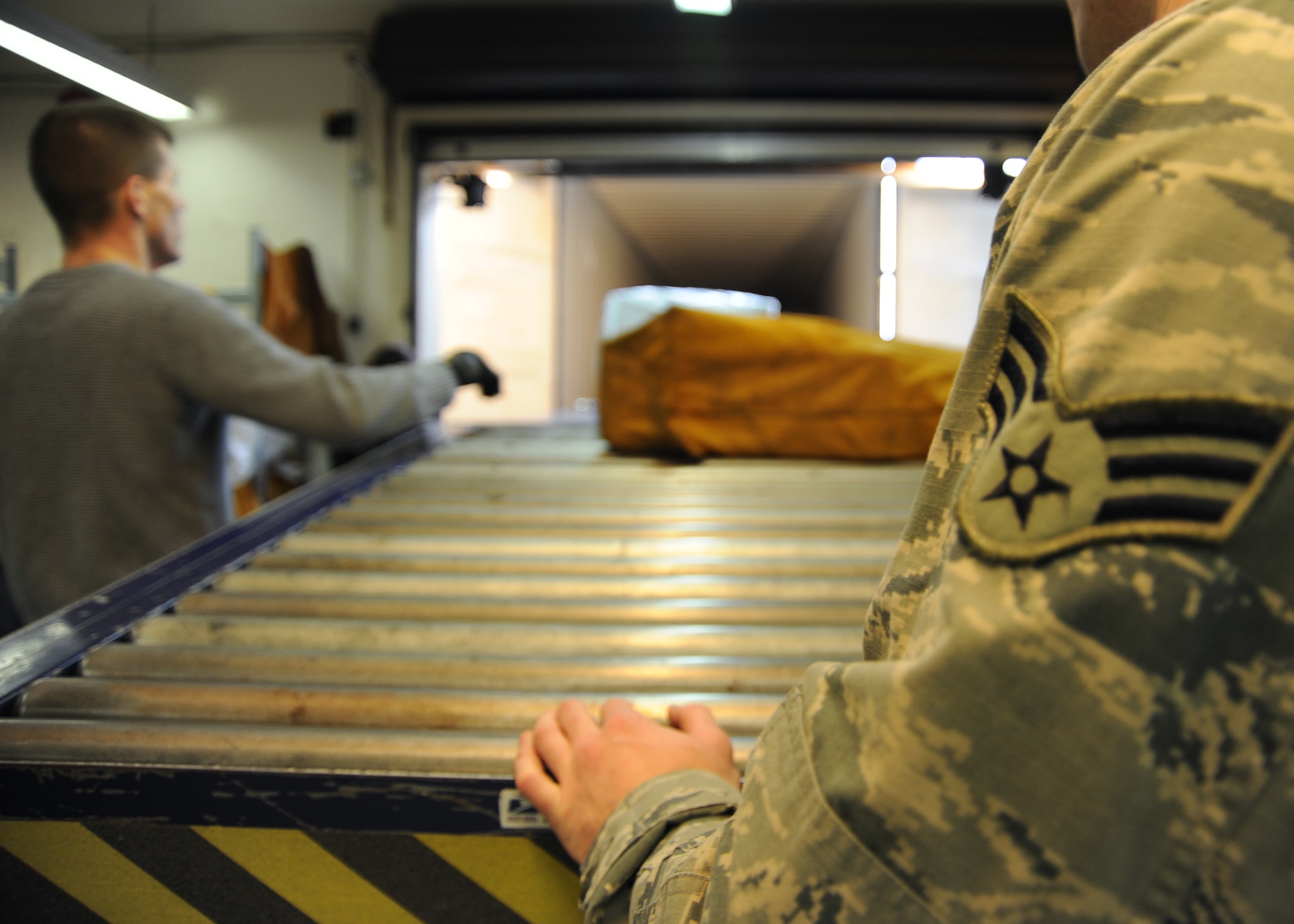 U.S. Air Force Senior Airman Matthew Baker, 52nd Communications Squadron military postal clerk, waits to off load mail from a delivery truck on Spangdahlem Air Base, Germany, Feb. 19, 2014. The Spangdahlem postal team received information that possible wet mail may arrive from the U.S. due to bad weather. Customers who receive wet mail can contact the post office customer service at 06565-61-4588 for information on how to file a claim. (U.S. Air Force photo by Airman 1st Class Dylan Nuckolls/Released)