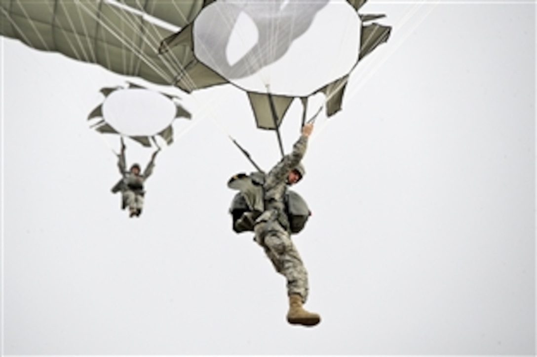 U.S. Army Staff Sgt. Joshua Livingston, front, conducts a training jump during an airborne operation at the 7th Army Joint Multinational Training Command's Grafenwoehr Training Area, Germany, Feb. 20, 2014. Livingston is a paratrooper assigned to 4th Battalion, 319th Airborne Field Artillery Regiment, 173rd Infantry Brigade Combat Team.