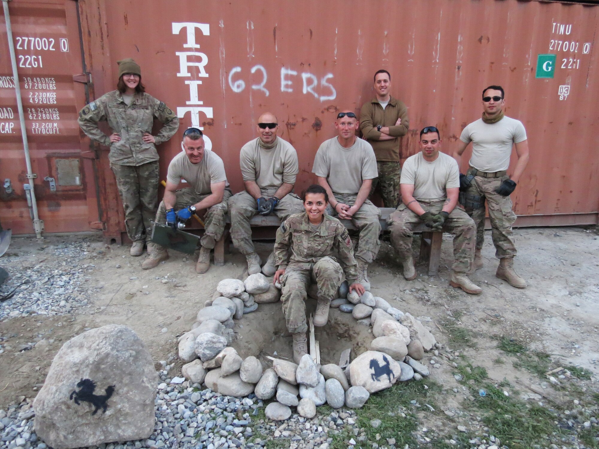 Airmen from the 451st Air Expeditionary Group relax around an outside morale area built for the 62nd Expeditionary Reconnaissance Squadron Detachment 1 at Jalalabad, Afghanistan, Feb. 14, 2014. The Black Stallion logo displays the pride put into just one of many projects completed by the group of Airmen that traveled in from Kandahar to assist with the work.(U.S. Air Force photo by Staff Sgt. Jeremy Wilkins/ Released)                               