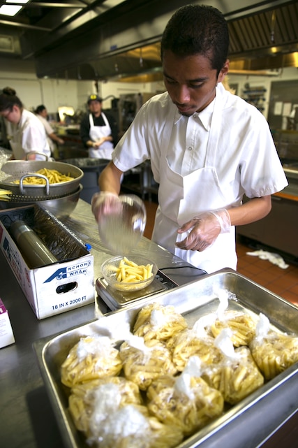 Mark Serpa-Cardenas, 17, 12th grader in high school, measures pasta noodles at the Combat Center Officer’s Club during the 11th Annual Job Shadowing Event, Feb. 19, 2014. “I enjoyed my time with the Job Shadowing program because it helped me to gain a new perspective on what the military actually does,” said Liz Evans, a 12th grader in high school, who shadowed a Combat Center journalist. “It helped me to further understand my career interest and how they conduct interviews and use different sources. It was useful, and I enjoyed it very much.” (Official Marine Corps Photo By Lance Cpl. Kasey Peacock/Released)