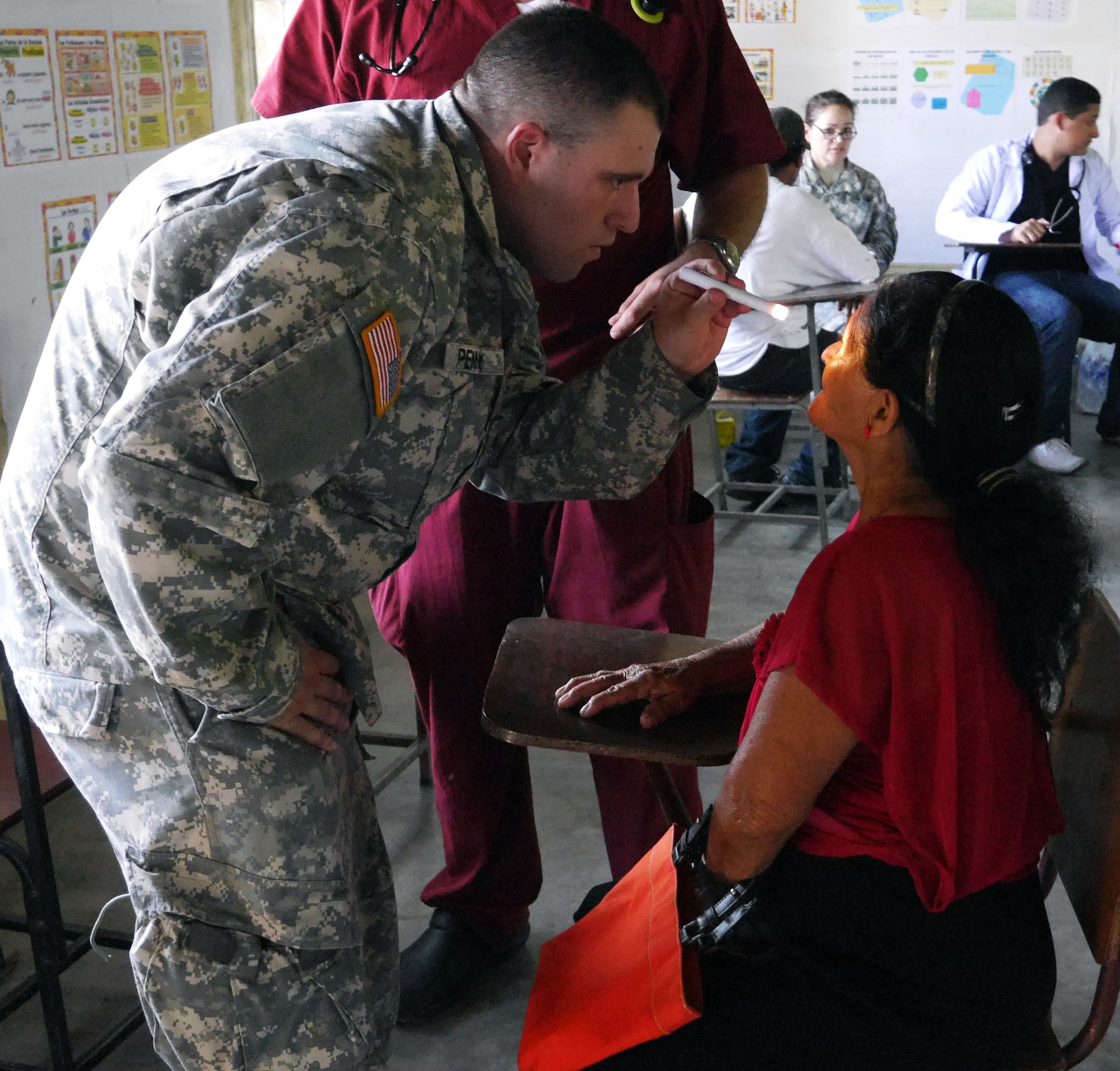 U.S. Army Sgt. Eric Penner examines a Honduran woman during a Medical Readiness Training Exercise (MEDRETE) conducted by Joint Task Force-Bravo's Medical Element (MEDEL) in the village of Kele Kele, Department of Puerto Cortes, Honduras, Feb. 26, 2014.  MEDEL, with support from JTF-Bravo Joint Security Forces, Army Forces Battalion, and the 1-228th Aviation Regiment, partnered with the Honduran Ministry of Health, the Honduran Red Cross, and the Honduran military to provide medical care to more than 1,100 people over two days in Kele Kele and Caoba, two remote villages in the Puerto Cortes region of Honduras.  (Photo by U.S. Army Sgt. Courtney Kreft)
