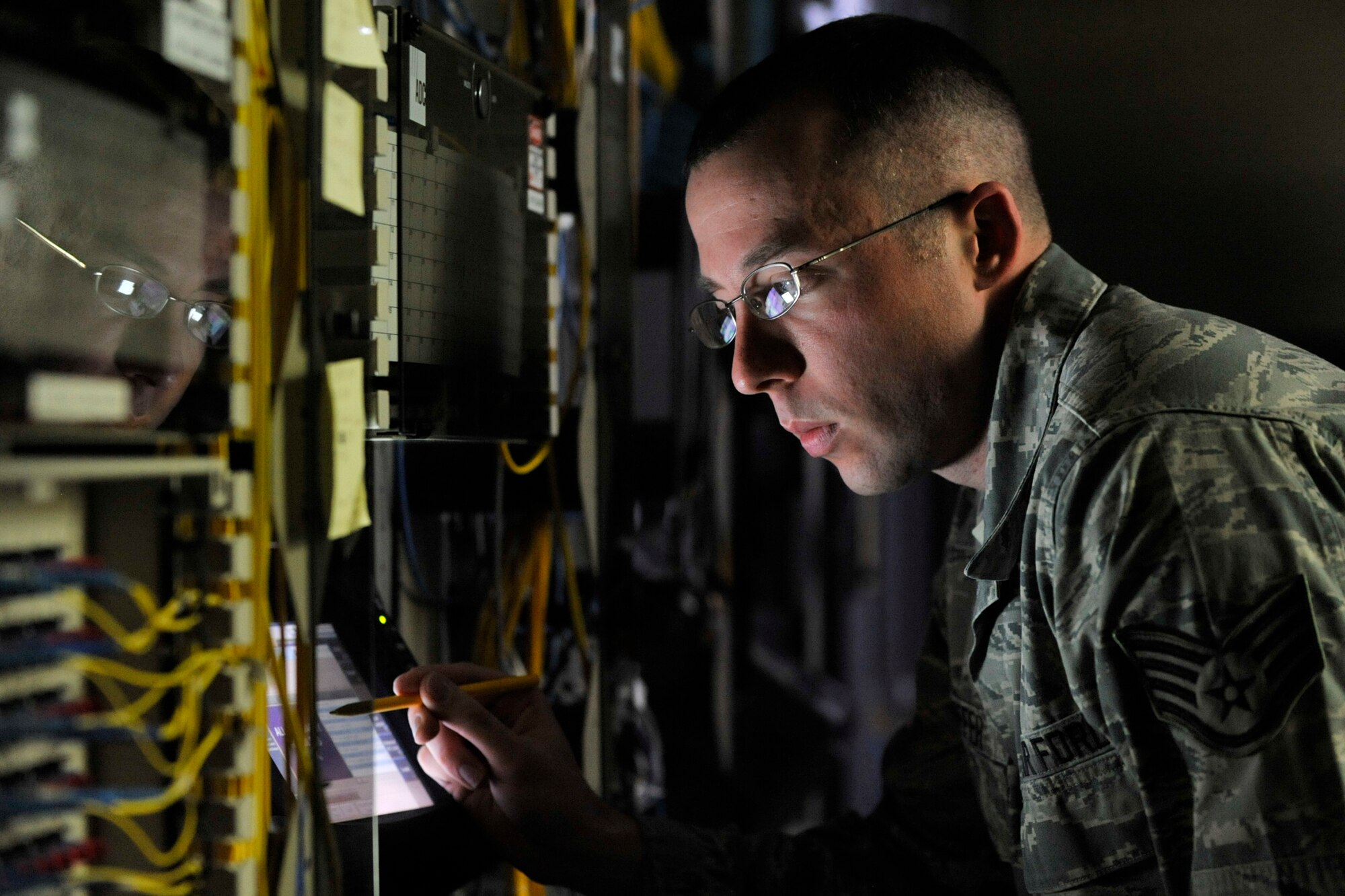 MISAWA AIR BASE, Japan – U.S. Air Force Staff Sgt. Michael Pfeiffer, 35th Communication Squadron cyber transport systems supervisor, uses an optical time domain refelectometer to run a test on a data circuit, at Misawa Air Base, Japan Feb. 21, 2014. The OTDR emits data in the form of light from the circuit to the end user to test the quality of the fiber optic cables. (U.S. Air Force photo/ Staff Sgt. Tong Duong)