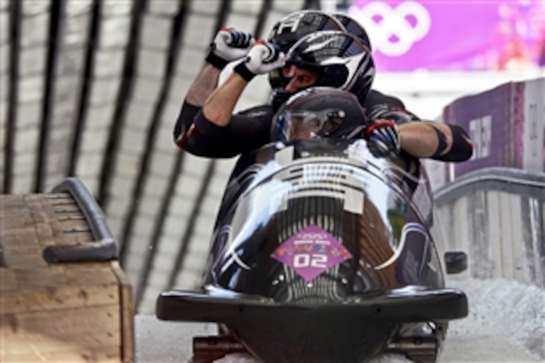 Former U.S. Army World Class Athlete Program bobsled driver Steven Holcomb and his crew of Curt Tomasevicz, Steve Langton and brakeman Capt. Chris Fogt offer a double fist pump to indicate USA-1 is ready to begin the third heat of the Olympic four-man bobsled competition at Sanki Sliding Centre in Krasnaya Polyana, Russia, Feb. 23, 2014. The bobsled quartet followed with a final run of 55.33 seconds to secure the bronze medal with a four-heat cumulative time of 3:40.99.