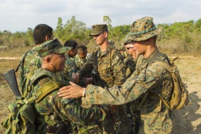 Royal Thai Marine Capt. Jirapan Sukpimai, left, shakes hands with U.S. Marine Lance Cpl. James P. Soccodato Feb. 12 after a full day of jungle patrolling training at Ban Chan Krem, Kingdom of Thailand. Royal Thai Marines and U.S. Marines are currently taking part in Exercise Cobra Gold, which is a multinational and multiservice exercise that takes place annually in the Kingdom of Thailand and was developed by the Thai and U.S. militaries. The day’s training consisted of Royal Thai Marines and U.S. Marines practicing various jungle patrolling tactics, techniques and procedures. Sukpimai is the company commander of 3rd Small Arms Company, 7th Battalion, 3rd Regiment, of the Marine Division. Soccodato is a tactical switching operator with Combat Logistics Battalion 4, Combat Logistics Regiment 3, 3rd Marine Logistics Group, III Marine Expeditionary Force.