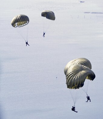 Greek paratroopers prepare for a water landing after jumping out the back of a U.S. Air Force C-130J Super Hercules during Stolen Cerberus, a two-week flying, training deployment designed to incorporate various training methods in order to maintain proficiency during deployed operations and increase interoperability with the Hellenic Air Force, Feb. 2 to 14. The mission provided the U.S. and Hellenic Air Forces a unique opportunity to learn how each service performs airlift operations, improving the joint capabilities of both nations. (U.S. Air Force photo/Staff Sgt. Kris Levasseur)