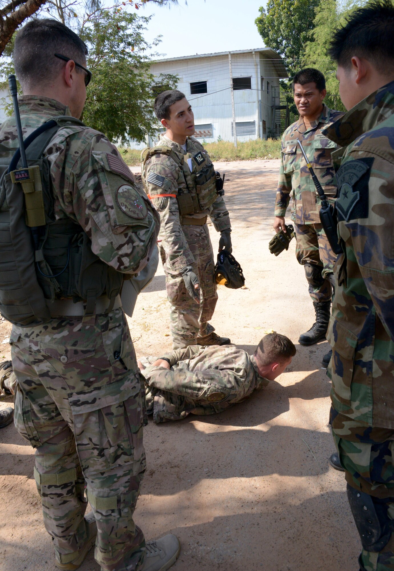 Staff Sgt. Javier Nunez, 353rd Special Operations Support Squadron, Deployed Aircraft Ground Response Element team member, demonstrates how to search a deceased person during a close quarter combat training scenario held Jan. 31, 2014 during Exercise Teak Torch held in Udon Thani, Thailand. This scenario-based training gave both the 353rd Special Operations Support Squadron DAGRE Team and their Royal Thai Air Force counterparts an opportunity to share different tactics and techniques. (U.S. Air Force photo by Tech. Sgt. Kristine Dreyer)