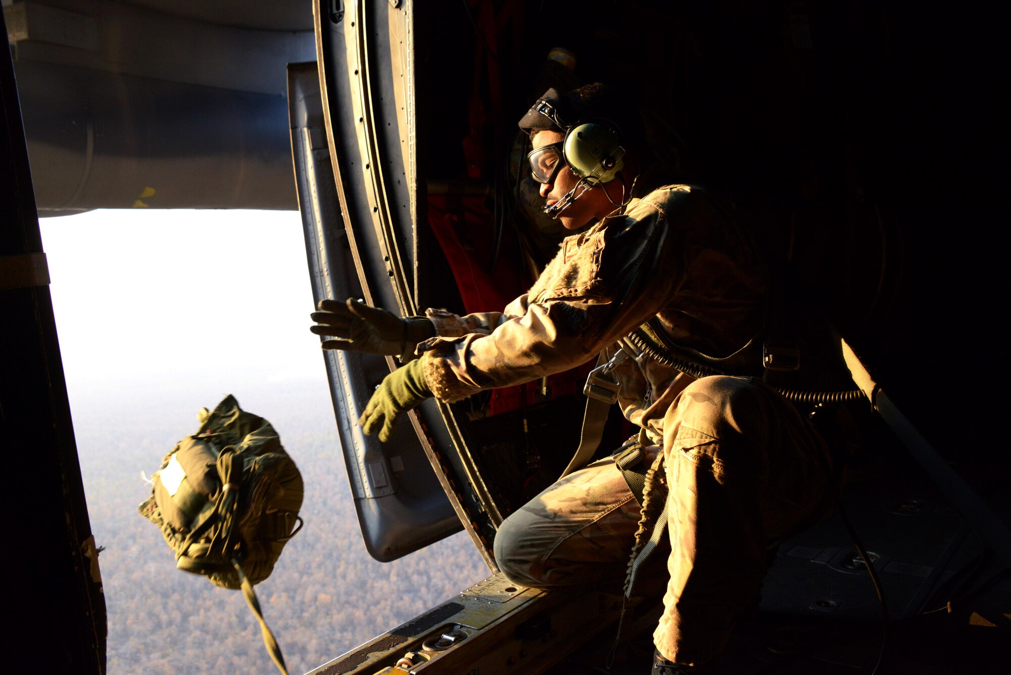 Tech. Sgt. David Wheeler, a loadmaster from the 17th Special Operations Squadron, drops a simulated airdrop training bundle from an MC-130P Combat Shadow over a drop zone near Udon Thani, Thailand. The MC-130P Combat Shadows from the 17th SOS are part of the 353rd Special Operations Group detachment from Kadena Air Base, Japan, in Thailand to participate in Exercise Teak Torch. (U.S. Air Force photo by Tech. Sgt. Kristine Dreyer)