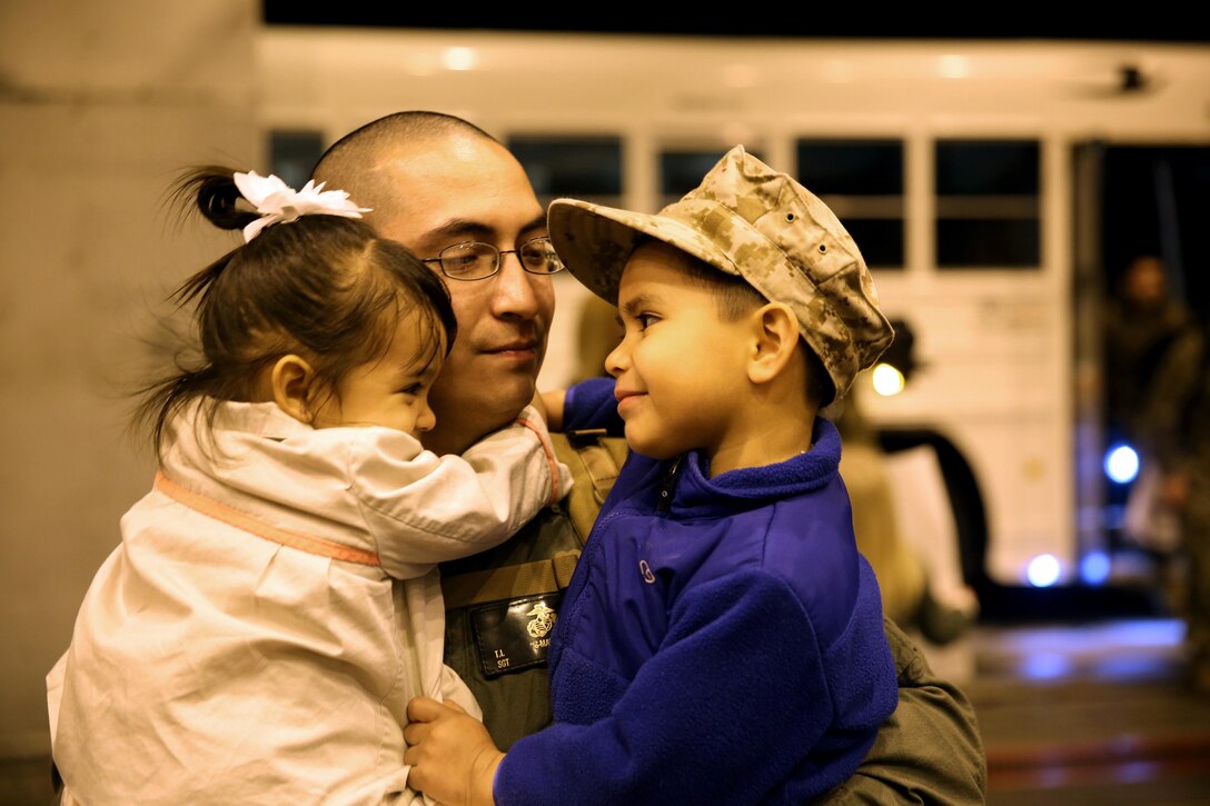 Sgt. Tino Garcia embraces his children Feb. 13 at Marine Corps Air Station Cherry Point after returning from a six-month deployment to Marine Corps Air Station Iwakuni, Japan, as part of a Unit Deployment Program rotation with Marine Tactical Electronic Warfare Squadron 2. More than 200 Marines and Sailors with VMAQ-2 and Marine Air Logistics Squadron 14 returned from the deployment. Garcia is a power-line mechanic with VMAQ-2.


