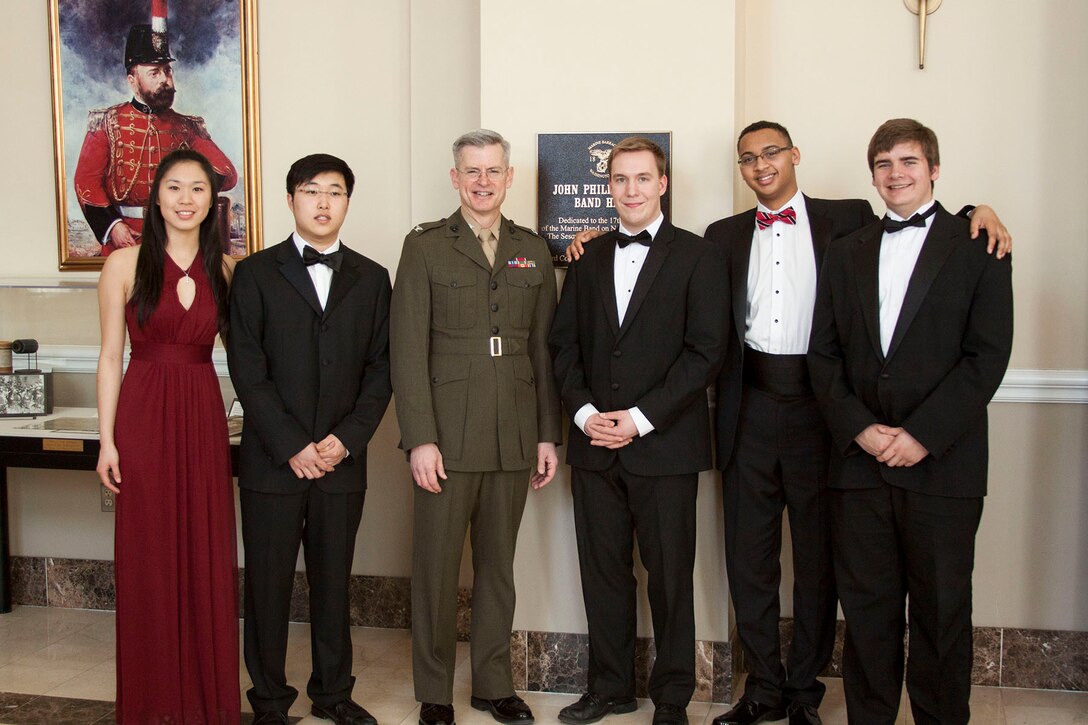 The 2014 Marine Band Concerto Competition finalists with Marine Band Director Col. Michael J. Colburn: (L to R) flutist Paulina Tsao of Ann Arbor, Mich.; bassoonist Alfred Yi of Woodway, Wash.; Col. Colburn; trombonist and competition winner Isaac Johnson of Pine Island, Minn.; euphonium player Joe Broom of McLean, Va.; and French horn player Mark Trotter of Seminole, Fla. (not pictured: saxophonist Chad Lilley of Olney, Md.). (U.S. Marine Corps photo by Staff Sgt. Brian Rust/released)