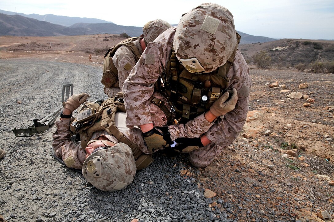 Marines with 1st Explosive Ordnance Disposal Company, 7th Engineer Support Battalion, simulate applying a tourniquet to an improvised explosive device victim during pre-deployment training aboard Camp Pendleton, Calif., Feb, 18, 2014. The Marines with 1st EOD have been training since September of last year in preparation for their upcoming deployment to Afghanistan next month in support of Operation Enduring Freedom.