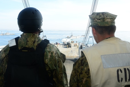 Rear Adm. Frank Ponds, commander of Expeditionary Strike Group Three, and Capt. Kevin Flanagan, commander of Naval Beach Group One, observe Improved Navy Lighterage System (INLS) Causeway Ferry 17 detach from the INLS Roll-on/Roll-off Discharge Facility during exercise Brilliant Scepter 2014. Brilliant Scepter 2014 is an exercise providing ship-to-shore transportation of combat cargo for Navy amphibious forces and the Marine Corps. (U.S. Navy photo by Mass Communication Specialist 2nd Class Scott Bigley/Released)