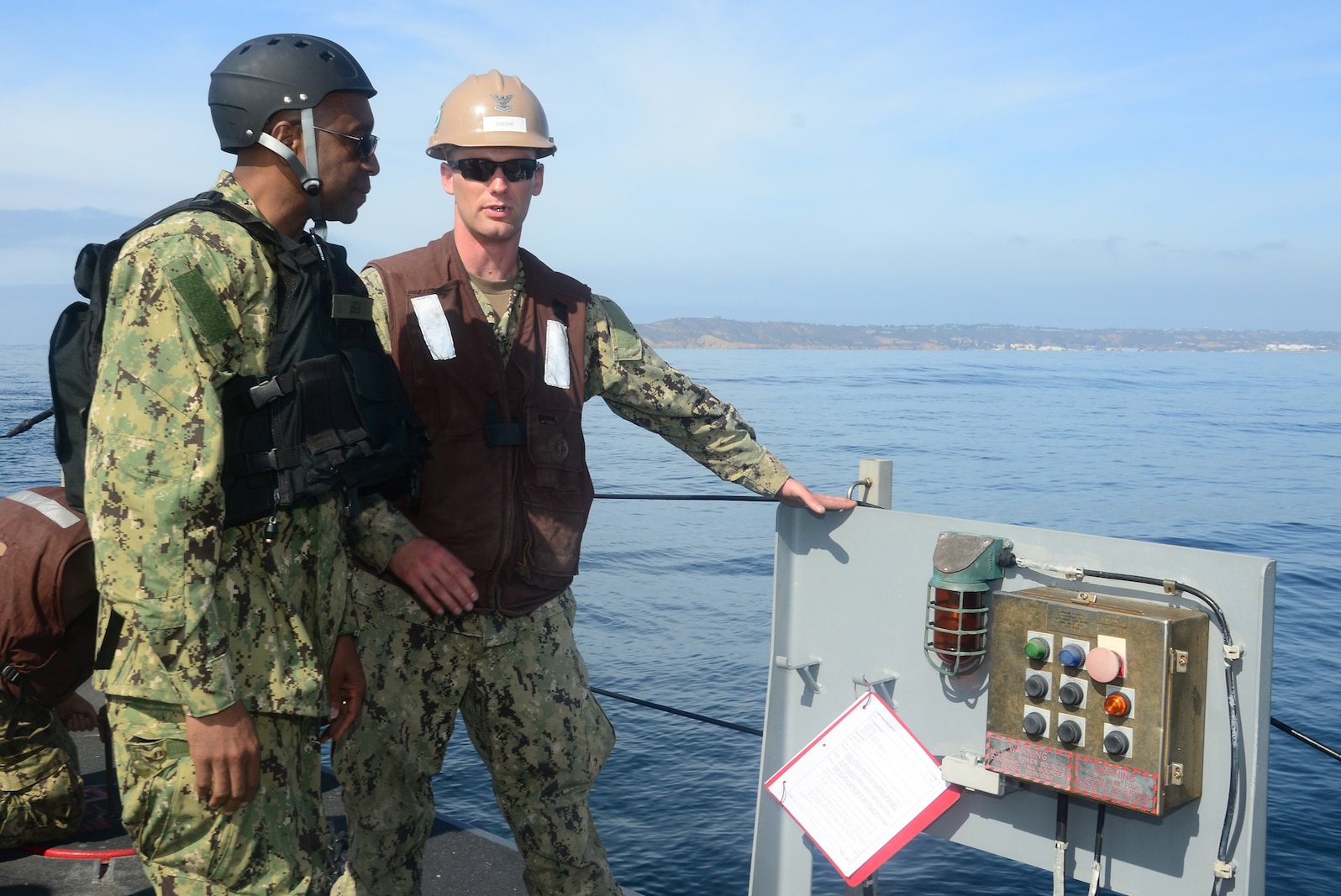 Engineman 2nd Class Jesse Couch, assigned to Amphibious Construction Battalion One, describes the operations of the beach module of Improved Navy Lighterage System Causeway Ferry 17 to Rear Adm. Frank Ponds, commander of Expeditionary Strike Group Three, during exercise Brilliant Scepter 2014. Brilliant Scepter 2014 is an exercise providing ship-to-shore transportation of combat cargo for Navy amphibious forces and the Marine Corps.