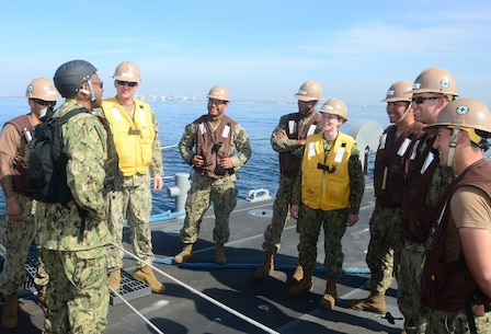 Rear Adm. Frank Ponds, commander of Expeditionary Strike Group Three, talks with the crew of Improved Navy Lighterage System Causeway Ferry 17, assigned to Amphibious Construction Battalion One, during exercise Brilliant Scepter 2014. Brilliant Scepter 2014 is an exercise providing ship-to-shore transportation of combat cargo for Navy amphibious forces and the Marine Corps.
