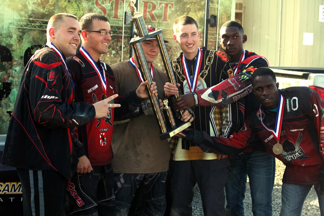 Combat Logistics Regiment 17, 1st Marine Logistics Group Marines pose with their trophy after winning first place in the co-ed division of the Commanding General’s Cup paintball tournament, Feb. 20, 2014. Four out of the five CLR-17 teams placed in the tournament.