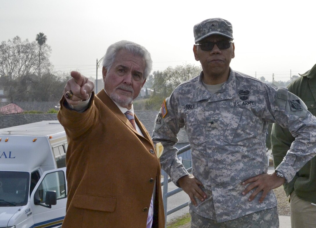 Brig. Gen. Dave Turner, South Pacific Division commander, observes Santa Clara Valley Water District (SCVWD), District 3 Director, Richard Santos, pointing to a proposed area for restoration of the Alviso Marina near the South Bay Yacht Club on Feb. 12, 2014, Alviso, Calif. Two Non-Federal Sponsors, the California Coastal Conservancy and SCVWD, teamed with USACE, San Francisco District Program Managers to present Turner with briefings of projects throughout Santa Clara County during a day-long tour of the region.