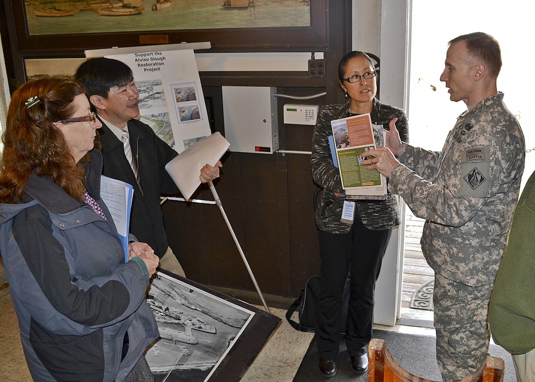 Lt. Col. John Baker, San Francisco District commander, speaks with Santa Clara Valley Water District (SCVWD) staff members Ngoc Nguyen and Norma Camacho, about a proposal for restoration of Alviso Slough on Feb. 12, 2014, Alviso, Calif.  Jane Hicks (left), USACE San Francisco District Regulatory Chief, was part of the Commander’s team participating in the day-long tour to provide guidance on USACE regulatory and permitting processes. SCVWD, one of two Non-Federal Sponsors partnering with USACE on projects in the San Francisco South Bay Area, hosted Brig. Gen. Dave Turner, South Pacific Division commander, and presented briefings of projects throughout Santa Clara County.