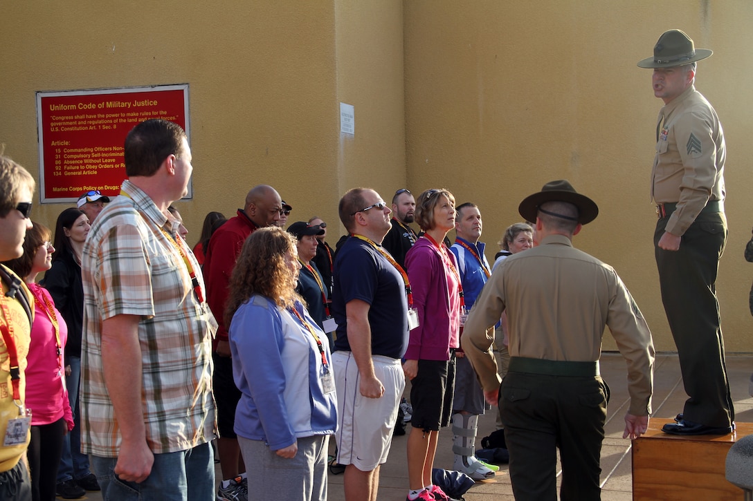 Educators from Recruiting Station Twin Cities greet a receiving drill instructor at the 2014 Educators Workshop, Feb. 10. During the workshop, educators had the opportunity to ask see what the Marine Corps is like, visit Marine Corps Recruit Depot San Diego and interact with Marines.