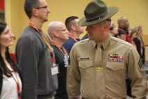 Educators from Recruiting Station Twin Cities greet a receiving drill instructor at the 2014 Educators Workshop, Feb. 10. During the workshop, educators had the opportunity to ask see what the Marine Corps is like, visit Marine Corps Recruit Depot San Diego and interact with Marines.