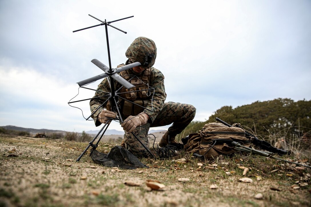 U.S. Marine Lance Cpl. Jose Carreon, 1st Battalion, 1st Marine Regiment, sets up satellite communications while conducting a helo insertion to a nighttime urban terrain raid training during Exercise Iron Fist 2014 aboard Camp Pendleton, Calif., Feb. 18, 2014. Iron Fist is an amphibious exercise that brings together Marines and sailors from the 15th Marine Expeditionary Unit, other I Marine Expeditionary Force units, and soldiers from the JGSDF, to promote military interoperability and hone individual and small-unit skills through challenging, complex and realistic training. (U.S. Marine Corps photo by Cpl. Emmanuel Ramos/Released)