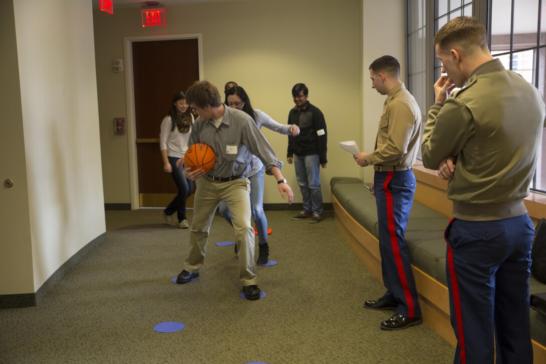 Second Lt. Christopher Perino, guest instructor at the Marine Corps Leadership Seminar (MCLS), watches over Virginia Commonwealth University students as they execute a training exercise designed to help utilize their leadership skills, Feb. 21. The MCLS is a program designed to spread awareness of the Marine Corps as well as teach college students valuable leadership traits and characteristics.

