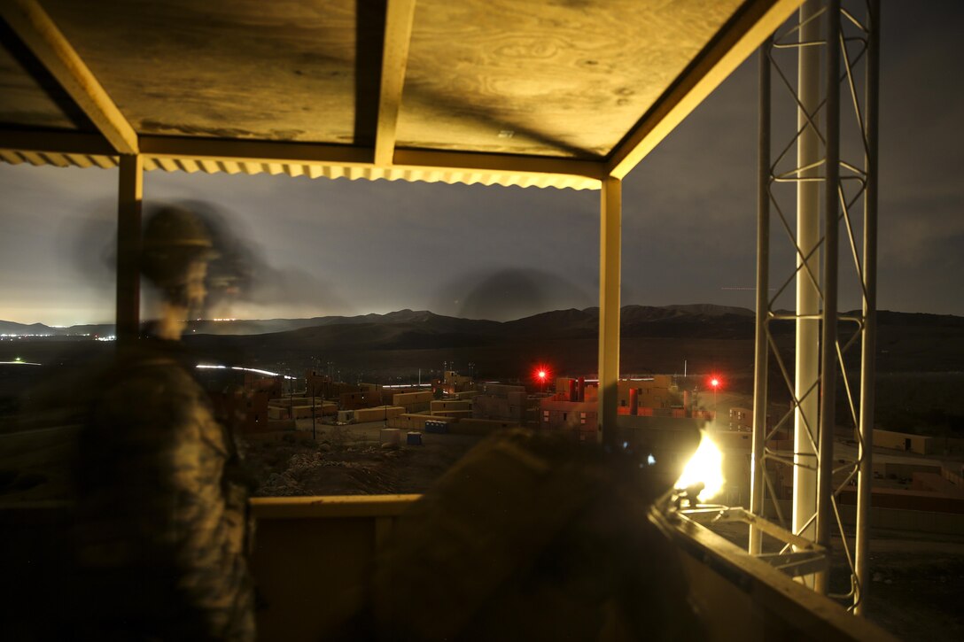 U.S. Marine Lance Cpl. Jarred Leggett, 1st Battalion, 1st Marine Regiment, provides cover fire while conducting a helo insertion to a nighttime urban terrain raid training during Exercise Iron Fist 2014 aboard Camp Pendleton, Calif., Feb. 18, 2014. Iron Fist is an amphibious exercise that brings together Marines and sailors from the 15th Marine Expeditionary Unit, other I Marine Expeditionary Force units, and soldiers from the JGSDF, to promote military interoperability and hone individual and small-unit skills through challenging, complex and realistic training. (U.S. Marine Corps photo by Cpl. Emmanuel Ramos/Released)
