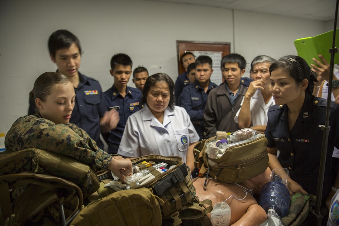 Petty Officer 3rd Class Kelcey Heath shows medical personnel from Wing One hospital supplies found in a medical technician’s pack at the Flight-line Aid Station aboard Wing One Royal Thai Air Force Base, Nakhon Ratchasima, Kingdom of Thailand, Feb. 10 as part of Exercise Cobra Gold 2014. CG 14 is an annual multinational exercise conducted in the Kingdom of Thailand designed to exercise multinational joint interoperability. Heath is a field medical technician with Marine Wing Support Squadron 171, Marine Aircraft Group 12, 1st Marine Air Wing, III Marine Expeditionary Force. (U.S. Marine Corps photo by Cpl. James R. Smith/released)