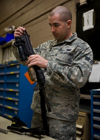 U.S. Air Force Staff Sgt. Zach Barkhymer, 99th Security Forces Squadron combat arms instructor, conducts a bi-annual weapons inspection Feb. 21, 2014, at Nellis Air Force Base, Nev. Barkhymer took apart the gun and inspected every element to ensure proper operation.  (U.S. Air Force photo by Senior Airman Jason Couillard)