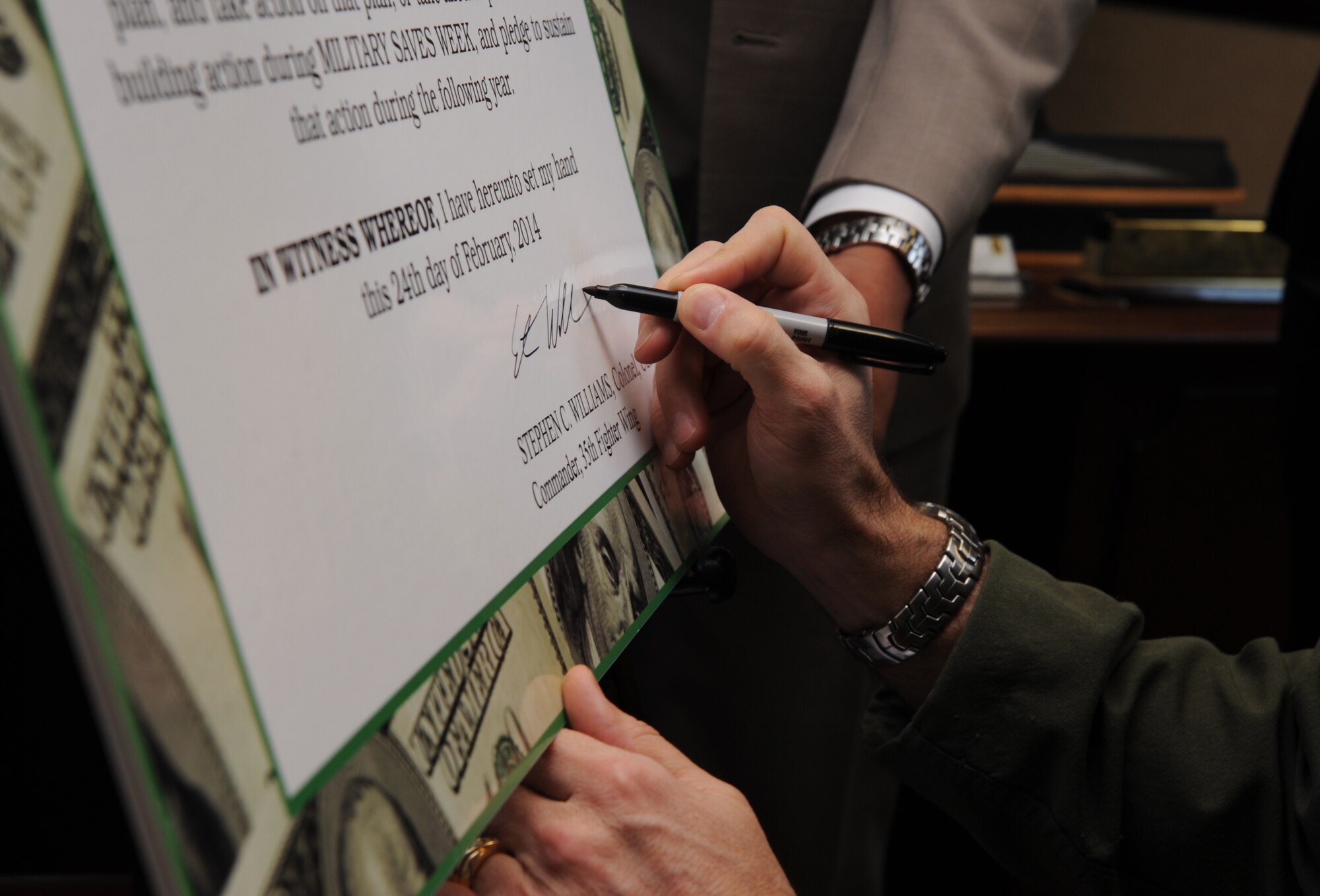 Col. Stephen Williams, 35th Fighter Wing commander, signs the 2014 Military Saves Week proclamtion Feb. 25, 2014, at Misawa Air Base, Japan, marking the kick off of this week-long observance. Since 2003, Military Saves has served as annual Department of Defense financial readiness annual campaign to increase awareness of financial wellness. (U.S. Air Force photo/Staff Sgt. Alyssa C. Wallace)
 