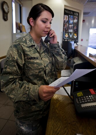 U.S. Air Force Senior Airman Laura Habbinga, 99th Security Forces Squadron visitors control center clerk, checks an entry authorization list Feb. 21, 2014, at Nellis Air Force Base, Nev. According to the Air Force website, one of the career tasks of a security forces specialist include ensuring the safety of all base weapons, property and members from hostile forces. (U.S. Air Force photo by Senior Airman Jason Couillard)