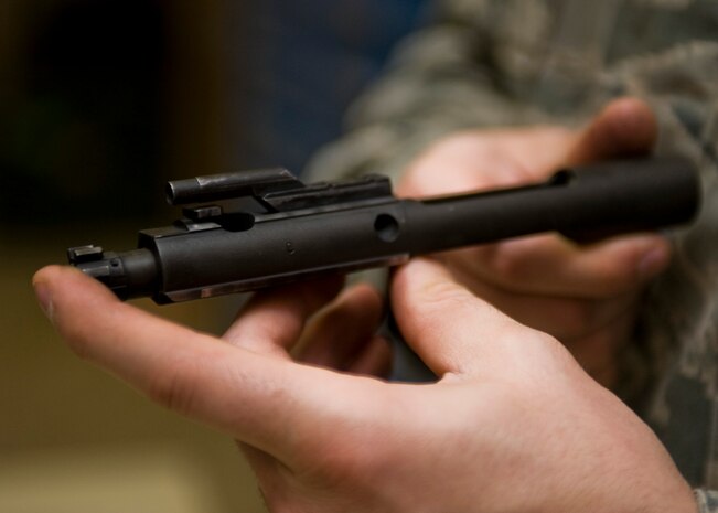 U.S. Air Force Staff Sgt. Zach Barkhymer, 99th Security Forces Squadron combat arms instructor, conducts a bi-annual weapons inspection Feb. 21, 2014, at Nellis Air Force Base, Nev. Combat arms specialists lead, manage, supervise and implement small arms weapons training programs. Their duties include operating firing ranges, enforcing range safety, inspecting and repairing weaponry, performing preventative maintenance, developing training aides and determining resource requirements. (U.S. Air Force photo by Senior Airman Jason Couillard)