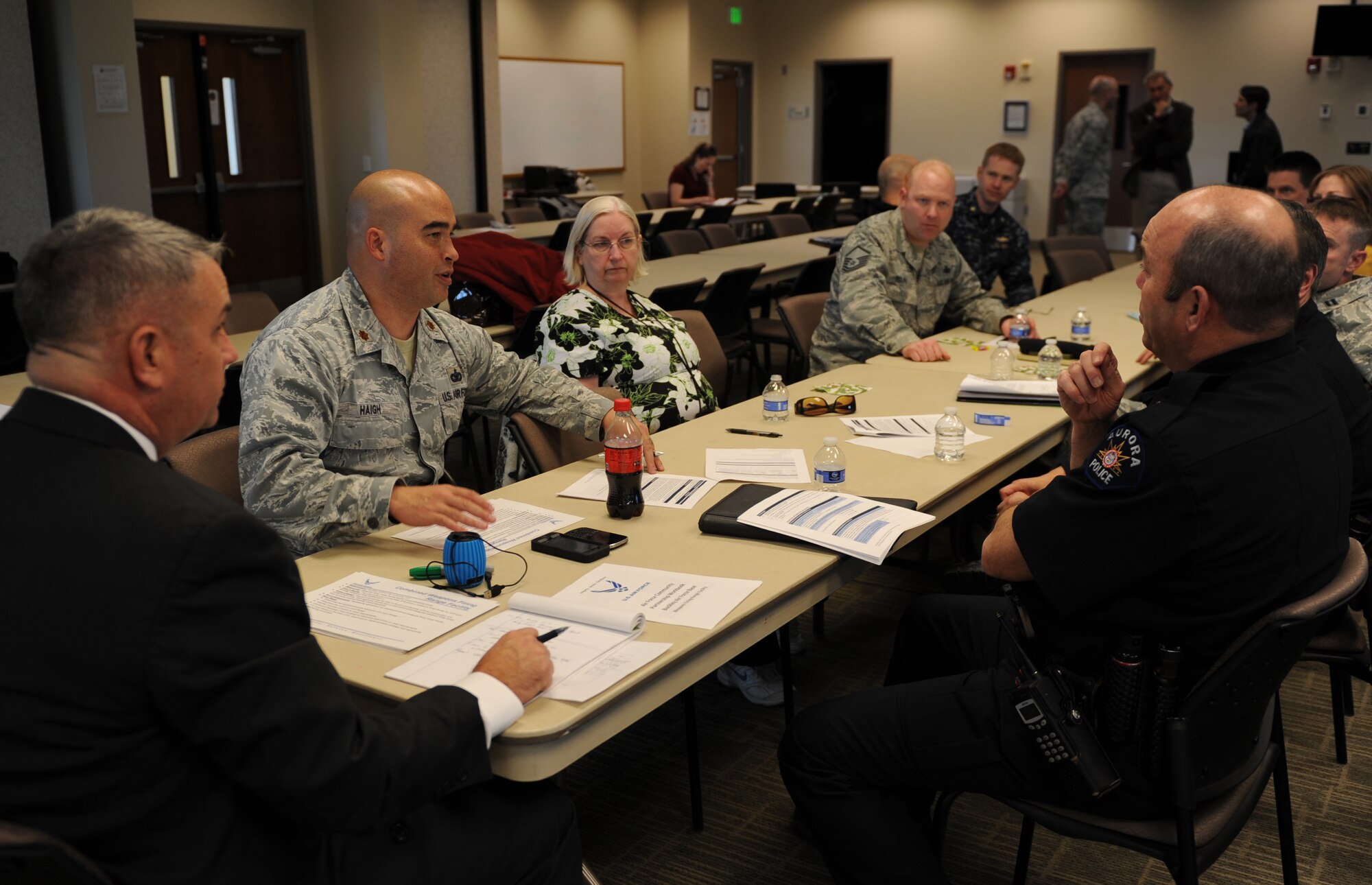 Community leaders and Team Buckley members discuss plans for the upcoming joint shooting range off base Feb. 21, 2014, at the chapel Fellowship Hall on Buckley Air Force Base, Colo. The shooting range agreement was later signed by Chief Daniel Oates, Aurora Police Department, and Maj. David Haigh, 460th Security Forces Squadron commander. This is just one of numerous actions taken towards the Public-Public & Public-Private, or P4, initiative. (U.S. Air Force photo by Airman Emily E. Amyotte/Released)