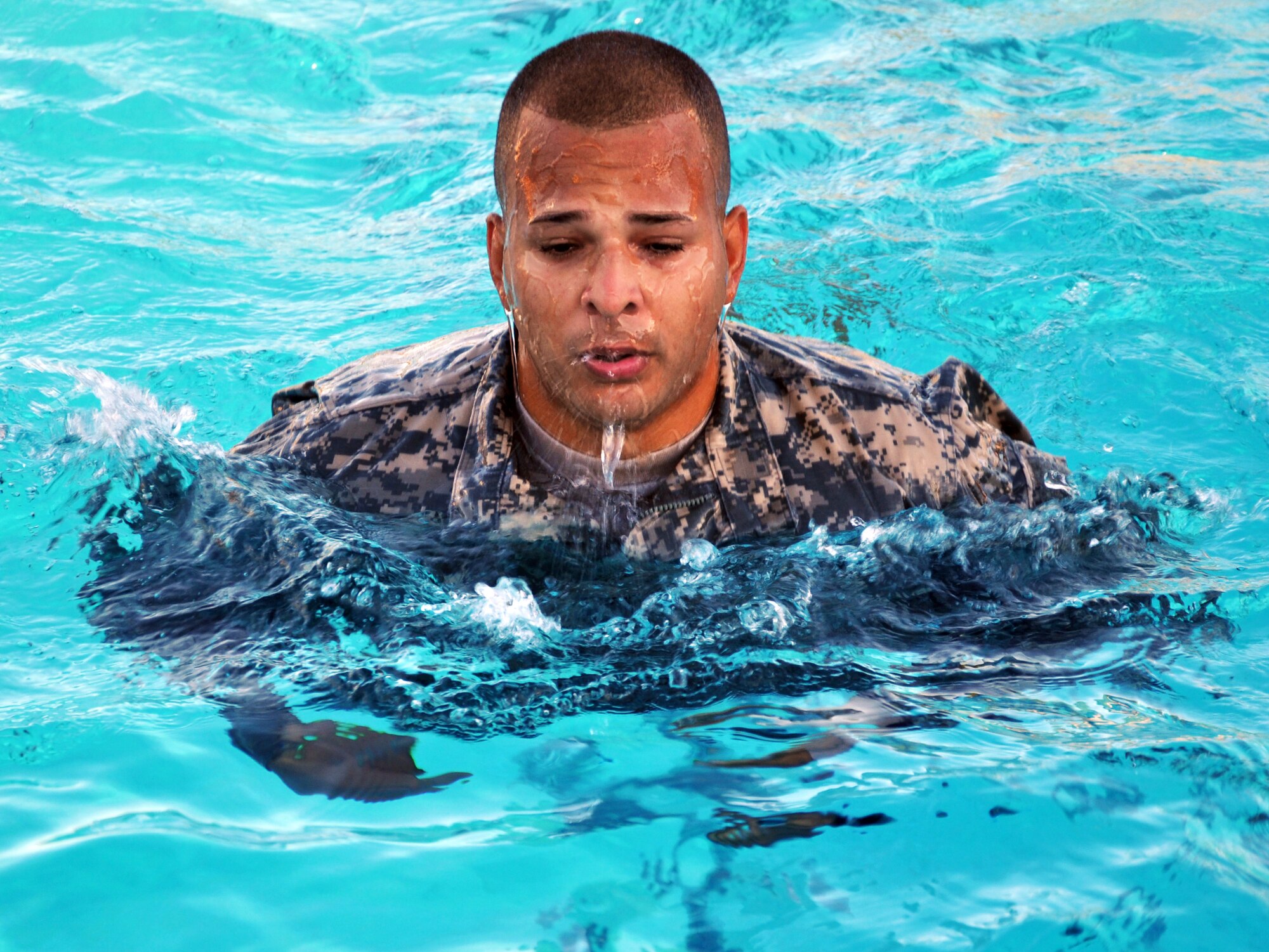 Members of Joint Task Force-Bravo took the Combat Water Survival Test (CWST) at Soto Cano Air Base, Honduras, Feb. 24, 2014. The testing was conducted in the base swimming pool, and required participants to accomplish tasks including swimming 50 meters in uniform and boots, and treading water and floating for five minutes. JTF-Bravo members also trained on helocasting techniques as well as procedures for recovery from water via hoist. The training was conducted in preparation for future JTF-Bravo exercises and operations. (U.S. Air Force photo by Capt. Zach Anderson)