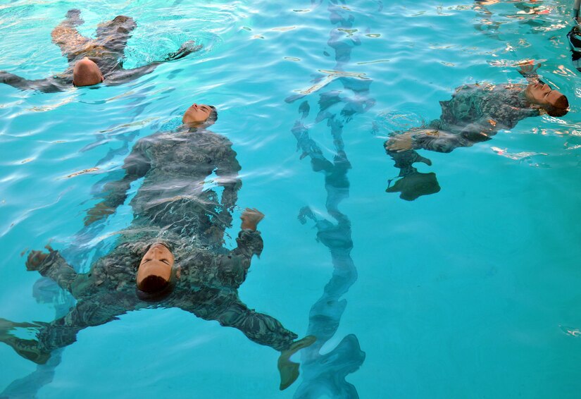 Members of Joint Task Force-Bravo took the Combat Water Survival Test (CWST) at Soto Cano Air Base, Honduras, Feb. 24, 2014. The testing was conducted in the base swimming pool, and required participants to accomplish tasks including swimming 50 meters in uniform and boots, and treading water and floating for five minutes. JTF-Bravo members also trained on helocasting techniques as well as procedures for recovery from water via hoist. The training was conducted in preparation for future JTF-Bravo exercises and operations. (U.S. Air Force photo by Capt. Zach Anderson)