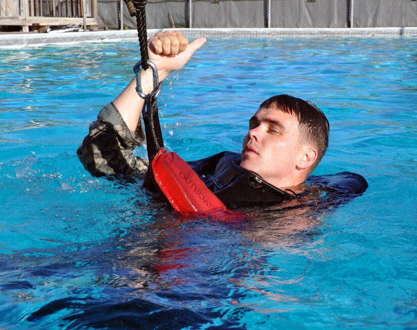 Members of Joint Task Force-Bravo took the Combat Water Survival Test (CWST) at Soto Cano Air Base, Honduras, Feb. 24, 2014. The testing was conducted in the base swimming pool, and required participants to accomplish tasks including swimming 50 meters in uniform and boots, and treading water and floating for five minutes. JTF-Bravo members also trained on helocasting techniques as well as procedures for recovery from water via hoist. The training was conducted in preparation for future JTF-Bravo exercises and operations. (U.S. Air Force photo by Capt. Zach Anderson)