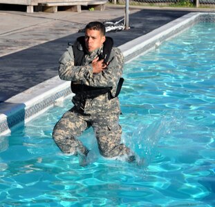 Members of Joint Task Force-Bravo took the Combat Water Survival Test (CWST) at Soto Cano Air Base, Honduras, Feb. 24, 2014. The testing was conducted in the base swimming pool, and required participants to accomplish tasks including swimming 50 meters in uniform and boots, and treading water and floating for five minutes. JTF-Bravo members also trained on helocasting techniques as well as procedures for recovery from water via hoist. The training was conducted in preparation for future JTF-Bravo exercises and operations. (U.S. Air Force photo by Capt. Zach Anderson)