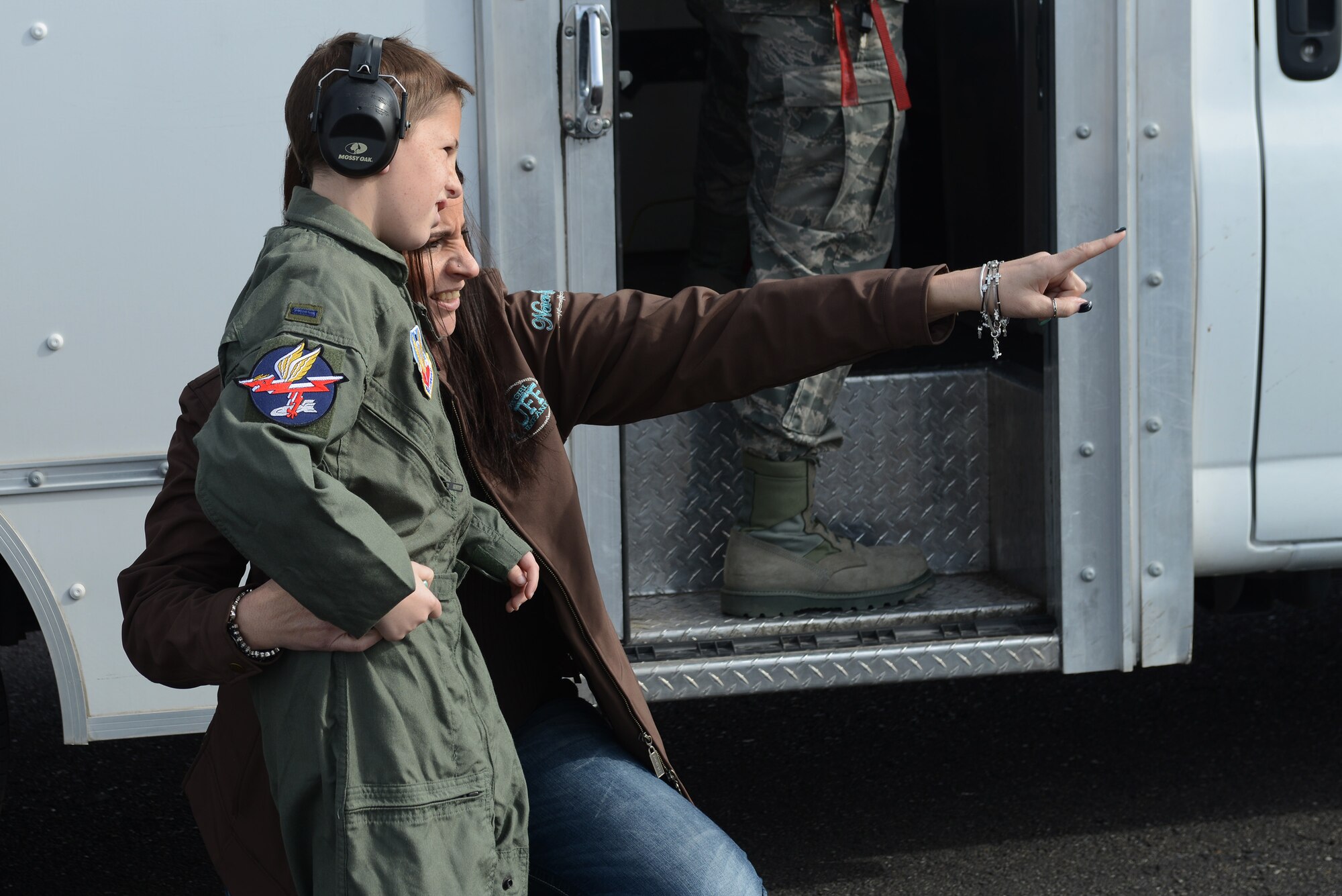 Ryan Trick along with his mother, Jackie Costa, watch aircraft land on the flightline of Mountain Home Air Force Base, Idaho, Feb. 21, 2014. Trick, who suffers from a rare form of brain cancer, visited the base as an honorary member of the 389th Fighter Squadron. He had the opportunity to wear a flight suit, see his name on a jet and even watch a take-off from the end of the runway. (U.S. Air Force photo by Senior Airman Benjamin Sutton/Released)     