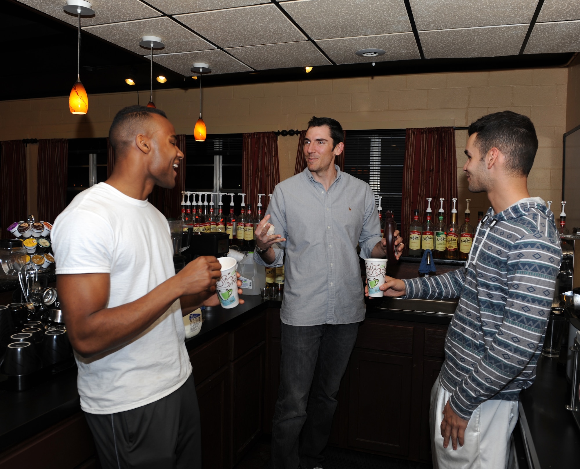 Matt Davis, center, Soul Fire Café manager, trains volunteers  U.S. Air Force Airman 1st Class Tracy Bowen Jr., left, and Airman 1st Class Luis Cruz, right, 7th Aircraft Maintenance Squadron, how to make beverages Feb. 20, 2014, at Dyess Air Force Base, Texas. The Soul Fire Café is a coffee shop and lounge for Airmen ran by the Dyess chapel. The hours of operation are fulfilled by volunteers who concoct non-alcoholic beverages and bake cookies for patrons. It also provides musical equipment, video games, ping-pong tables, and wireless internet access. (U.S. Air Force photo by Airman 1st Class Kedesha Pennant/Released)
