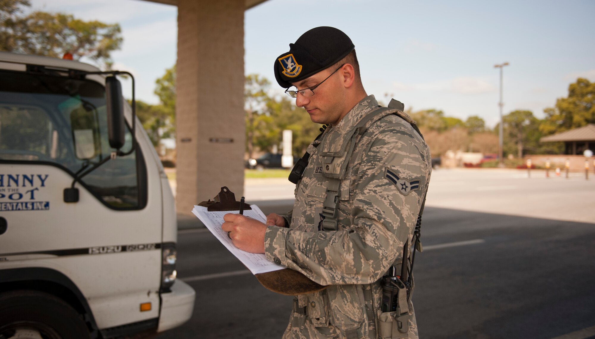 Airman 1st Class Richard Thomas, 1st Special Operations Security Forces Squadron alarm monitor, logs vehicle information at the commercial gate on Hurlburt Field, Fla., Feb. 24, 2014. (U.S. Air Force photo/Senior Airman Krystal M. Garrett) 