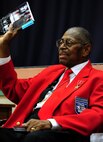 Retired Chief Master Sgt. Walter Richardson holds his book as he shares portions of his memoirs with Air Commandos at Hurlburt Field, Fla., Feb. 19, 2013. Richardson is an original member of the Tuskeegee Airmen and he shared his message of perseverance to encourage today’s military members. (U.S. Air Force photo/Staff Sgt. Victoria Sneed)