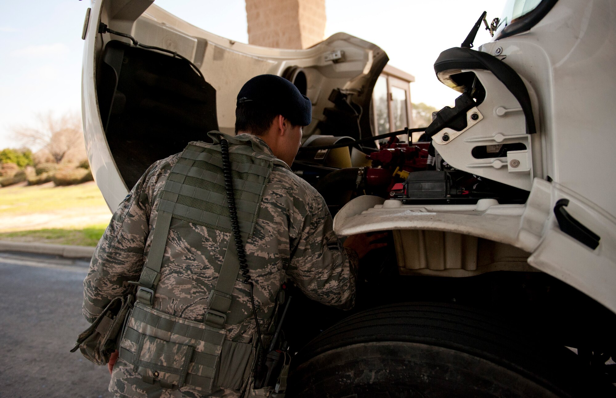 Airman 1st Class Brandon Eddy, 1st Special Operations Security Forces Squadron installation entry controller, checks under the hood of a vehicle during an inspection at the commercial gate on Hurlburt Field, Fla., Feb. 24, 2014. (U.S. Air Force photo/Senior Airman Krystal M. Garrett) 
