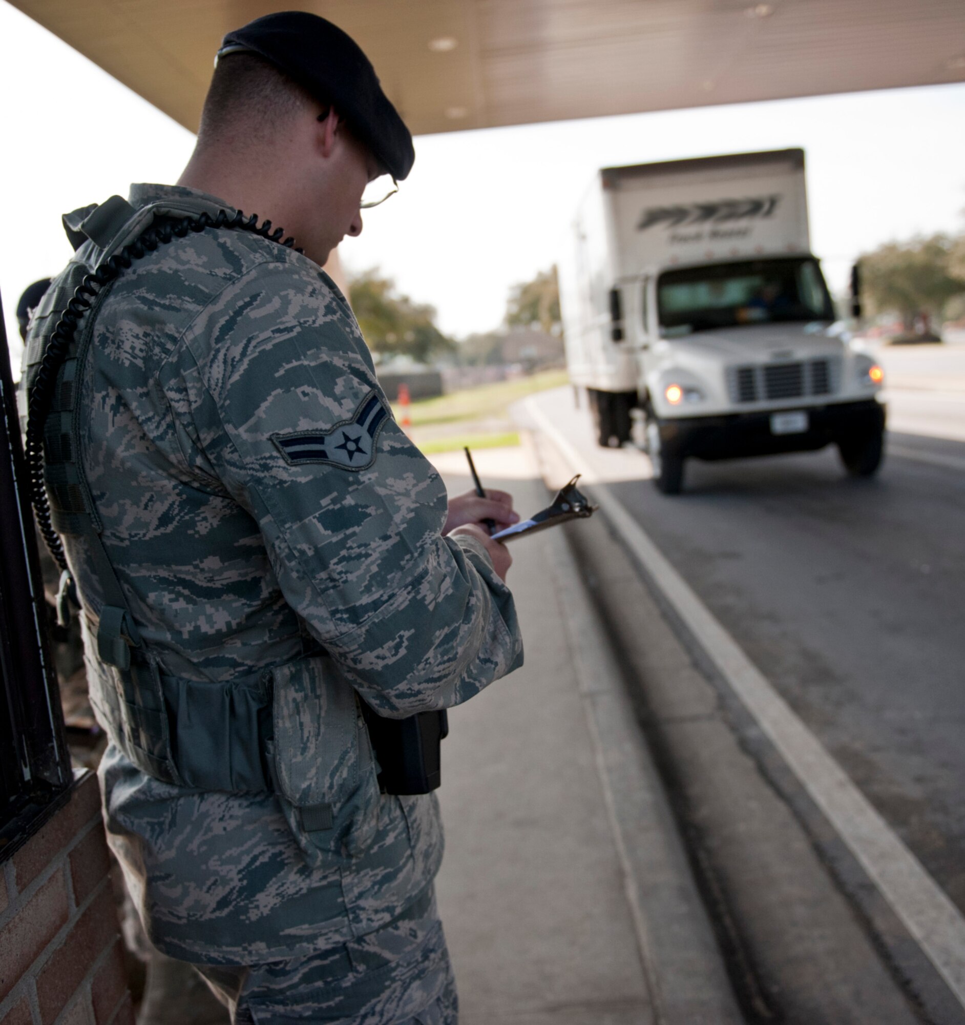 Airman 1st Class Richard Thomas, 1st Special Operations Security Forces Squadron alarm monitor, writes down information prior to inspecting a vehicle at the commercial gate on Hurlburt Field, Fla., Feb. 24, 2014. (U.S. Air Force photo/Senior Airman Krystal M. Garrett) 